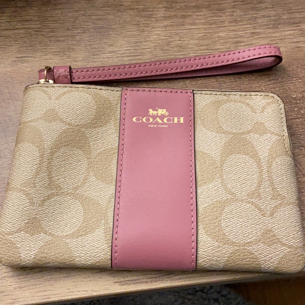 Tan and pink Coach wristlet.